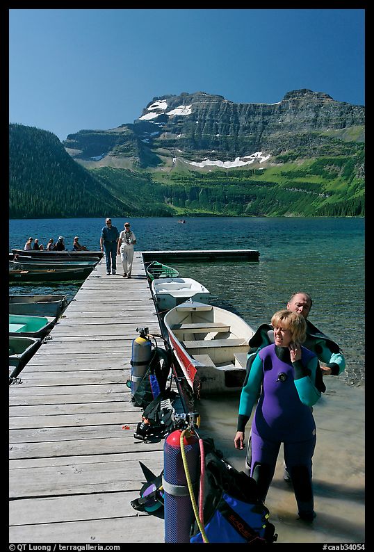 Couple preparing to scuba dive, Cameron Lake. Waterton Lakes National Park, Alberta, Canada