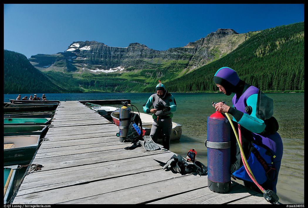 Scuba divers getting ready to dive, Cameron Lake. Waterton Lakes National Park, Alberta, Canada