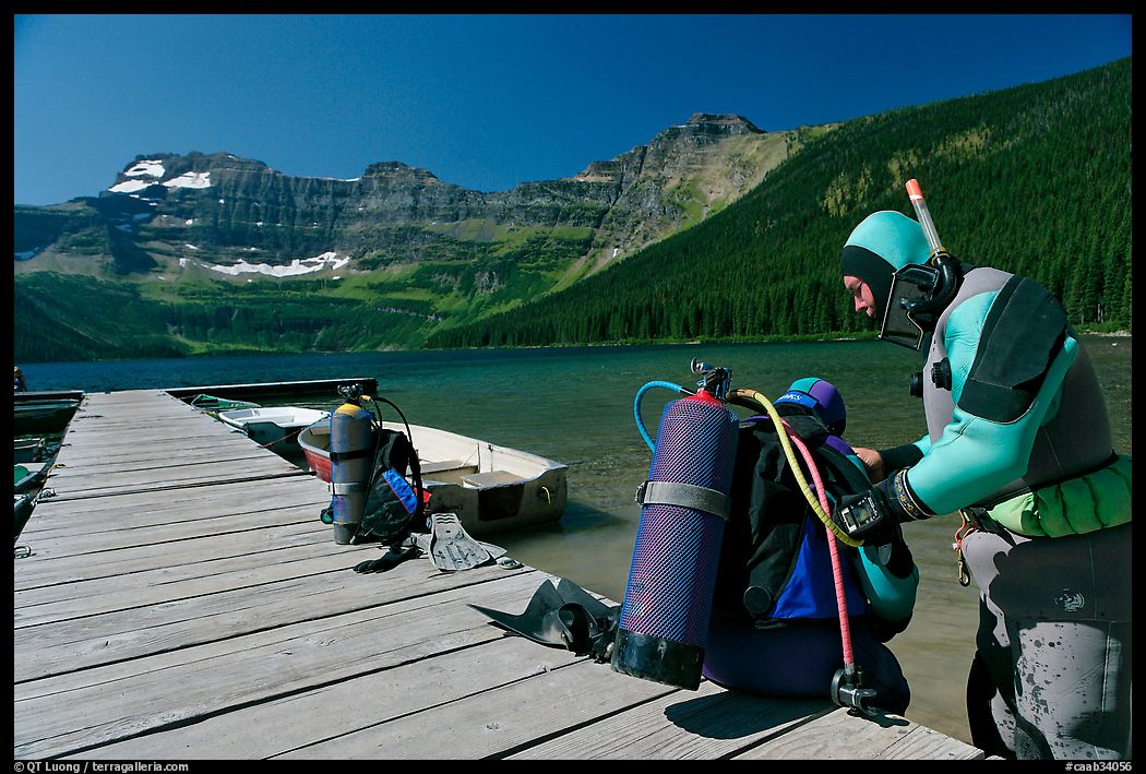 Scuba divers preparing to dive into cold waters of Cameron Lake. Waterton Lakes National Park, Alberta, Canada