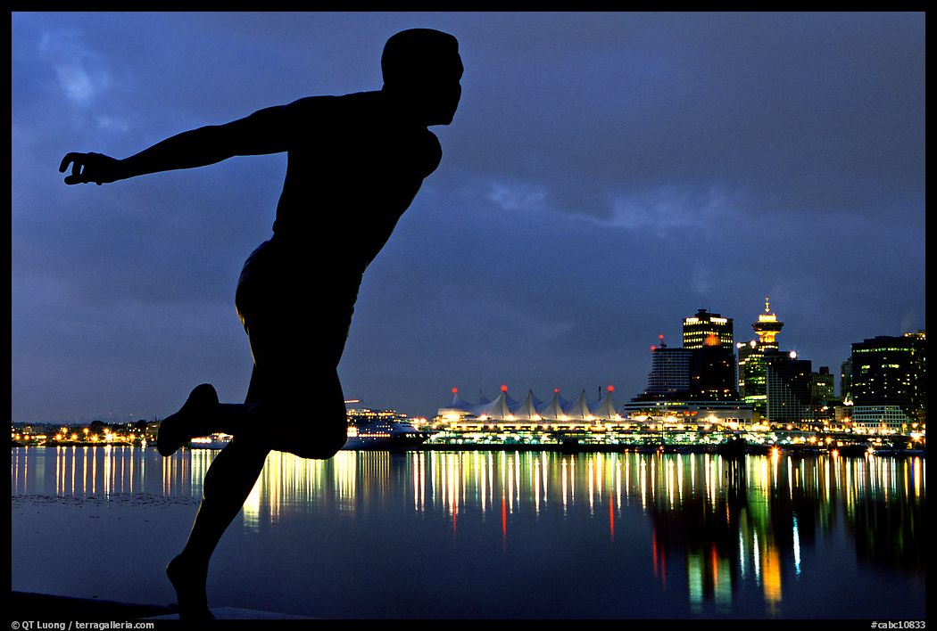 Harry Jerome (a former great sprinter)  statue and Harbor at night. Vancouver, British Columbia, Canada