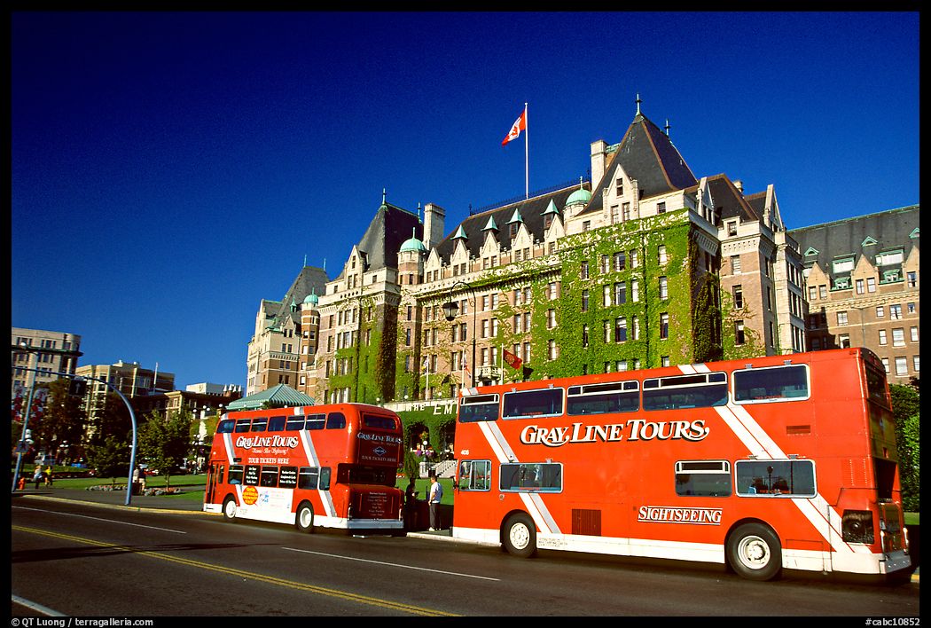 Red double-decker tour busses in front of Empress hotel. Victoria, British Columbia, Canada
