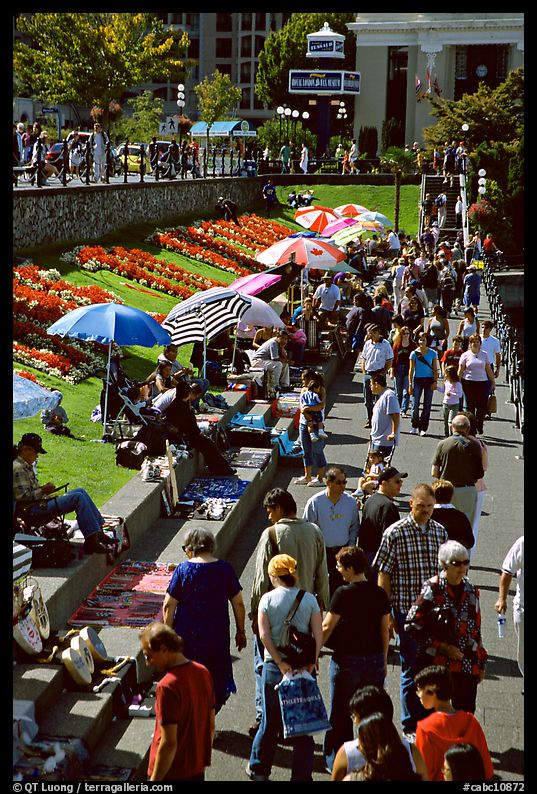 Visitors and art exhibitors on the quay of inner harbour. Victoria, British Columbia, Canada