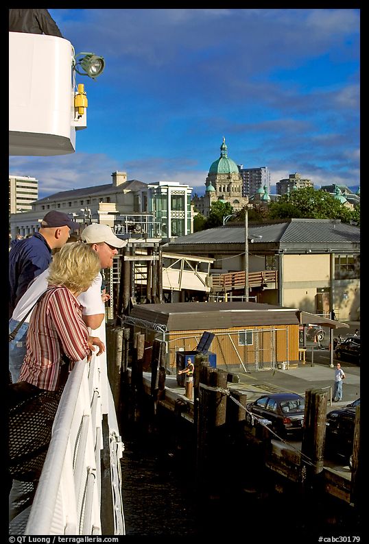 Passengers standing on the deck of the ferry, as it sails into the Inner Harbor. Victoria, British Columbia, Canada