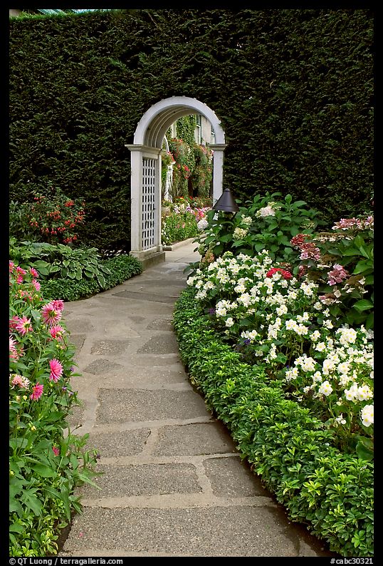 Arched entrance  leading to the Italian Garden. Butchart Gardens, Victoria, British Columbia, Canada