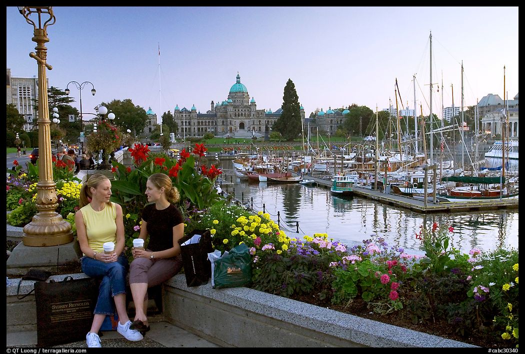 Young Women sitting, Inner harbor. Victoria, British Columbia, Canada