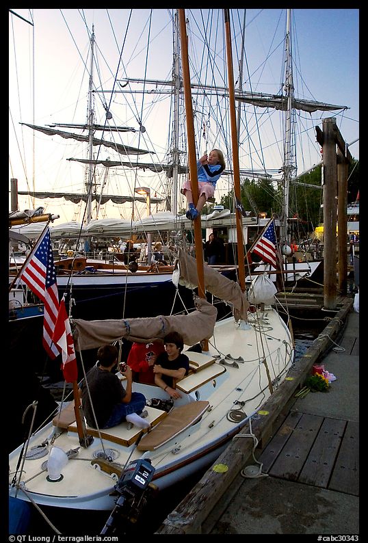 Kids in a small sailboat docked in Inner Habor. Victoria, British Columbia, Canada