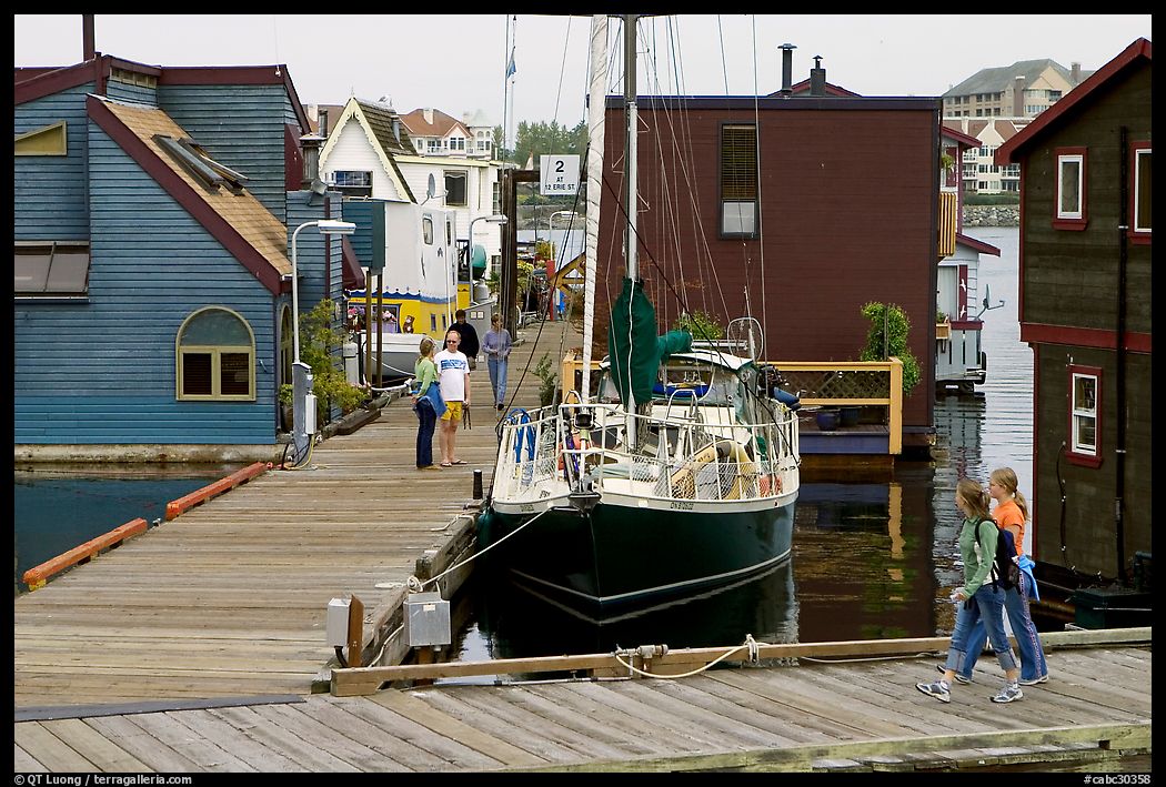 Houseboats, deck, and sailboat, Upper Harbour. Victoria, British Columbia, Canada