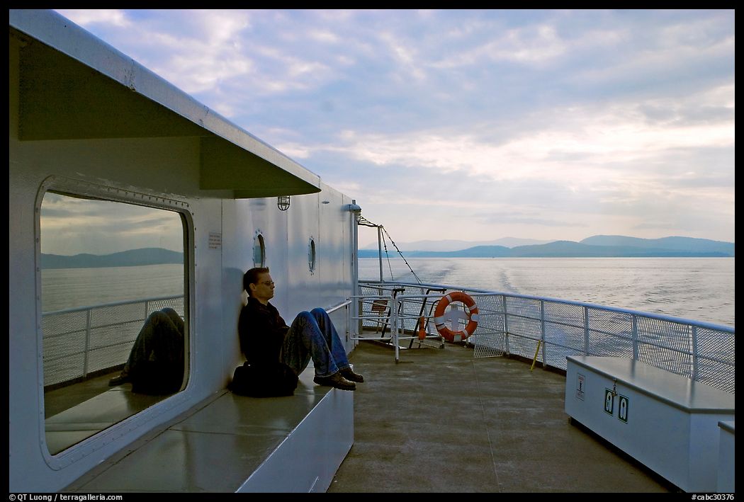 Passenger sitting on the deck of ferry. Vancouver Island, British Columbia, Canada