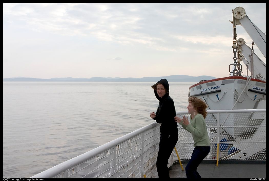 Woman and girl looking out from deck of ferry. Vancouver Island, British Columbia, Canada