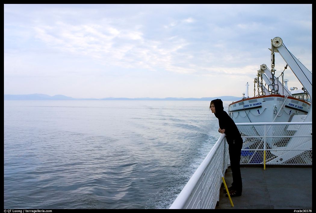 Woman looking out from deck of ferry. Vancouver Island, British Columbia, Canada