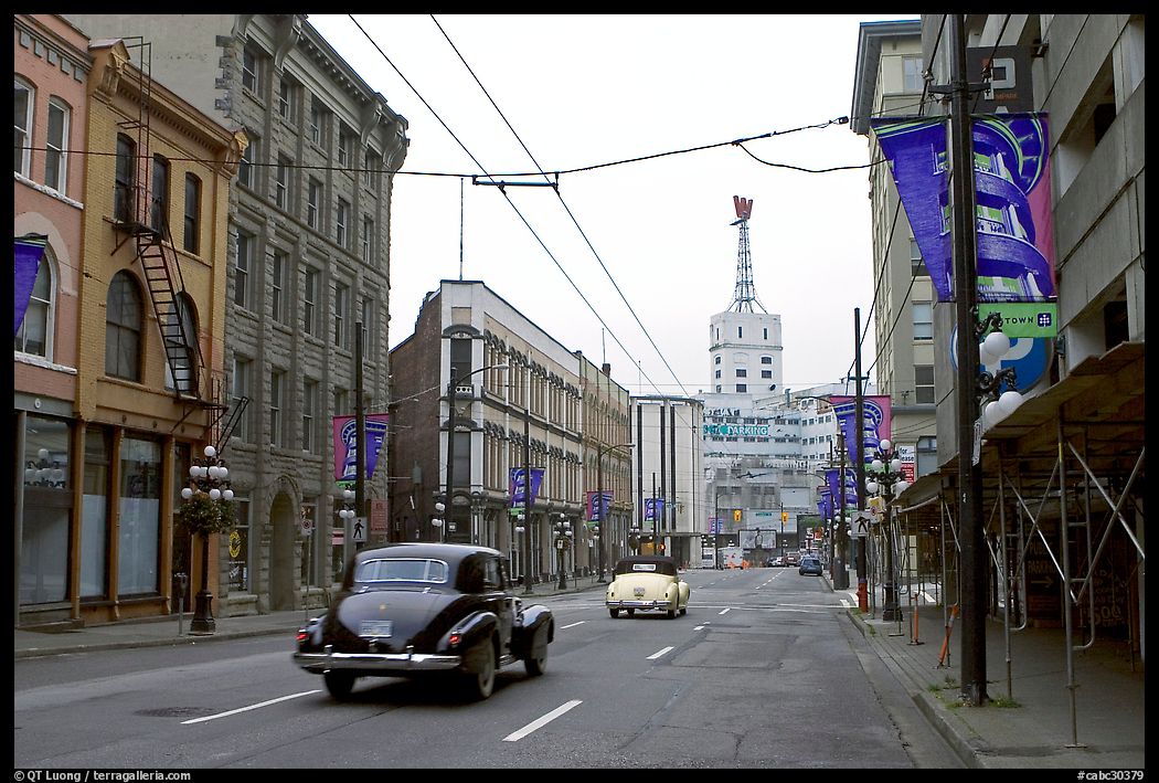Street in Gastown with two old cars. Vancouver, British Columbia, Canada