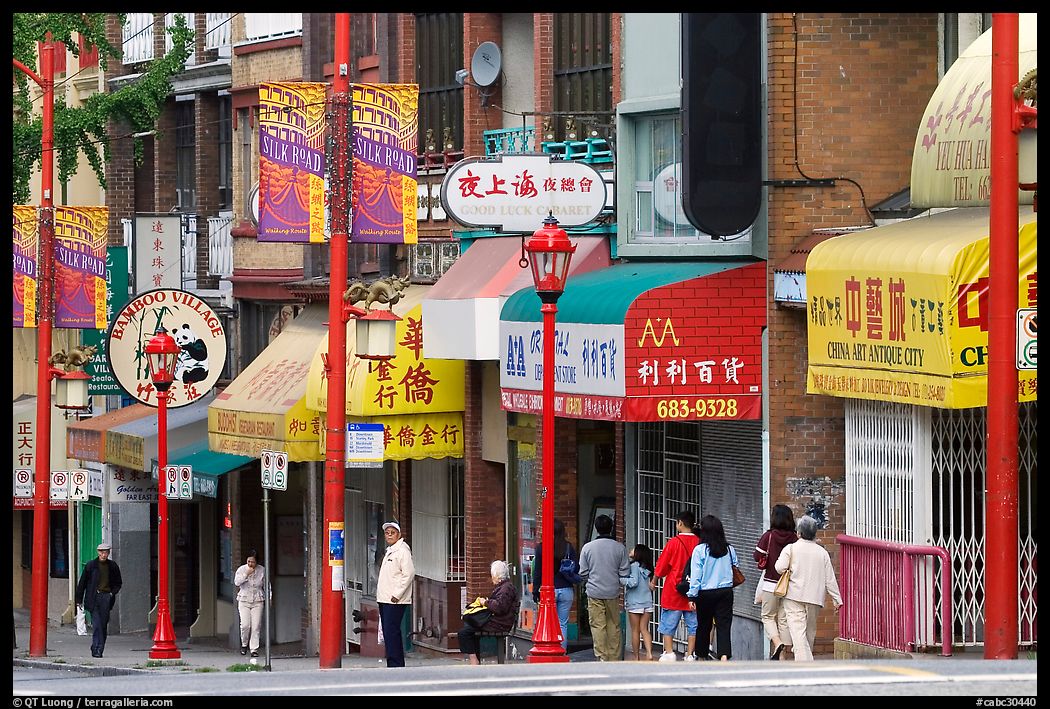 Street in Chinatown with red lamp posts and Chinese characters. Vancouver, British Columbia, Canada