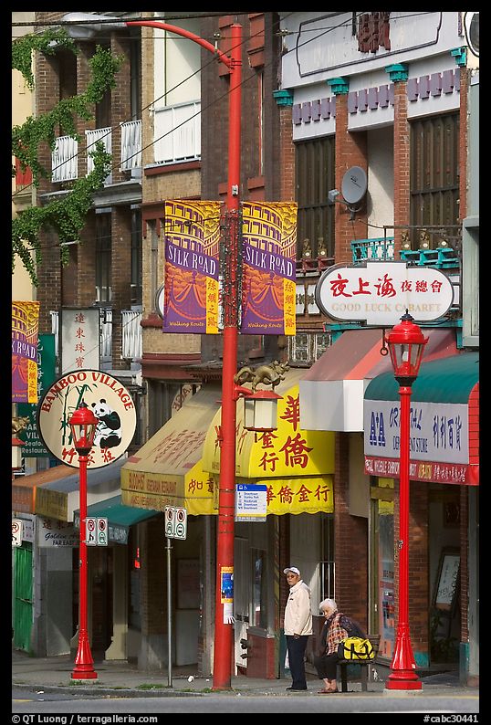 Street in Chinatown with red lamp posts and Chinese script. Vancouver, British Columbia, Canada