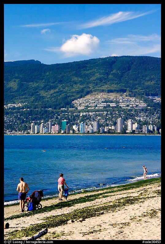 Family near the water on a beach, Stanley Park. Vancouver, British Columbia, Canada