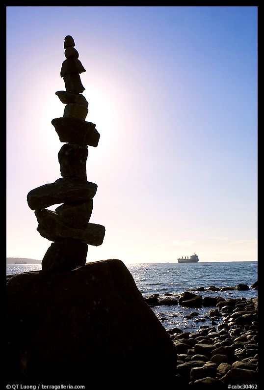 Backlit balanced rocks and ship in the distance. Vancouver, British Columbia, Canada
