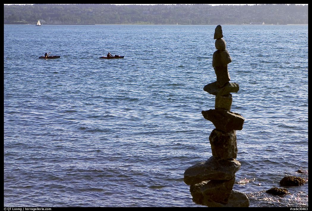 Balanced rocks and kayaks in a distance. Vancouver, British Columbia, Canada