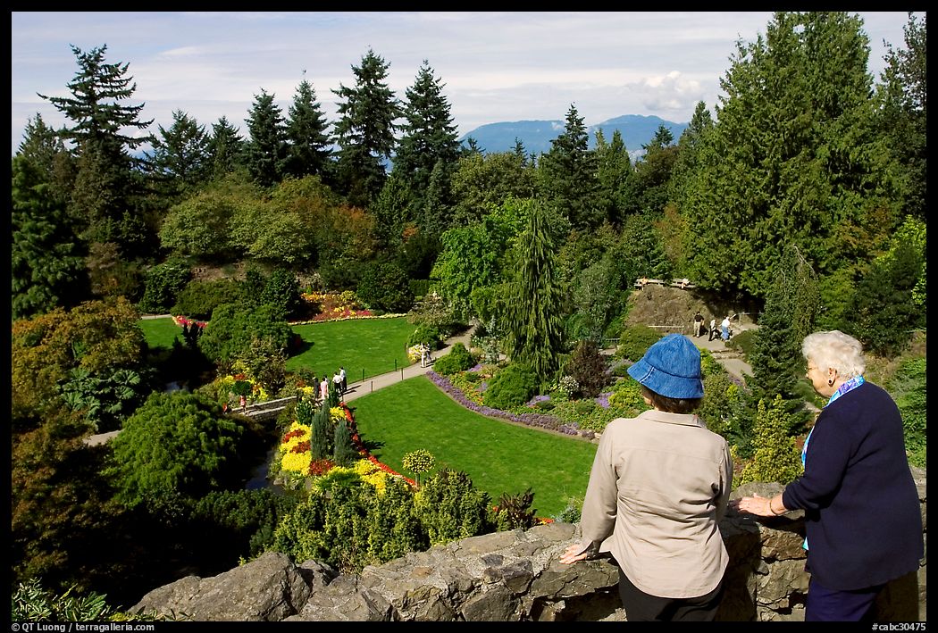Elderly couple looking at the Sunken Garden in Queen Elizabeth Park. Vancouver, British Columbia, Canada