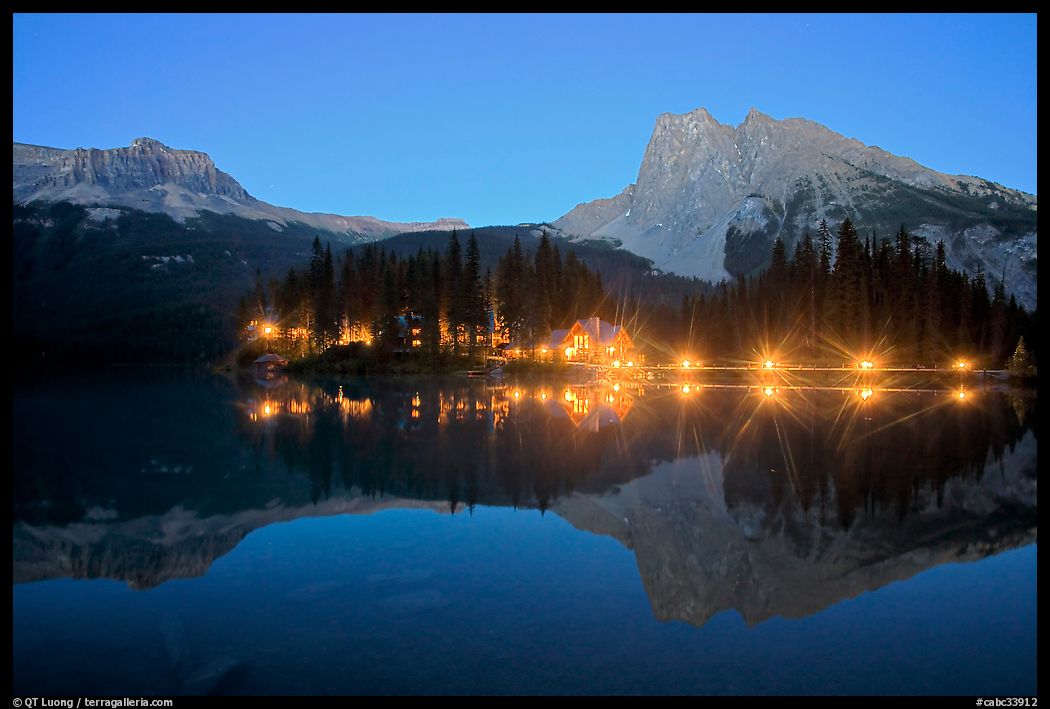 Lighted cabins and mountains reflected in Emerald Lake at night. Yoho National Park, Canadian Rockies, British Columbia, Canada