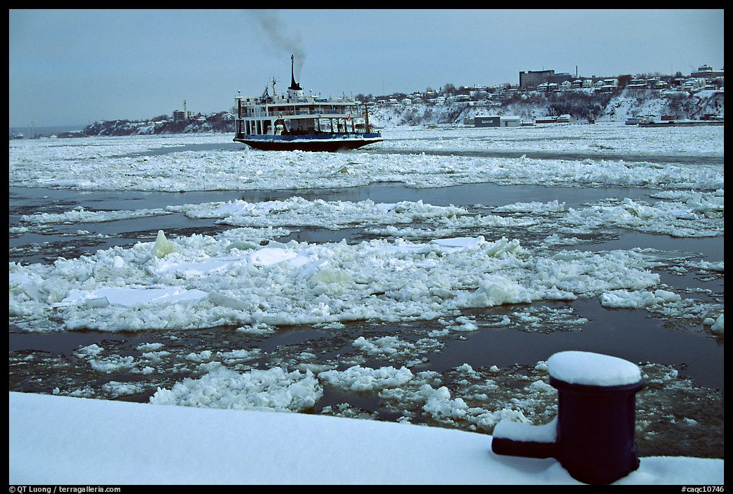 Ferry crossing the Saint Laurent river partly covered with ice, Quebec City. Quebec, Canada