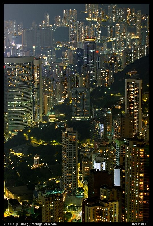 Residential towers on steep hillside from Victoria Peak by night. Hong-Kong, China