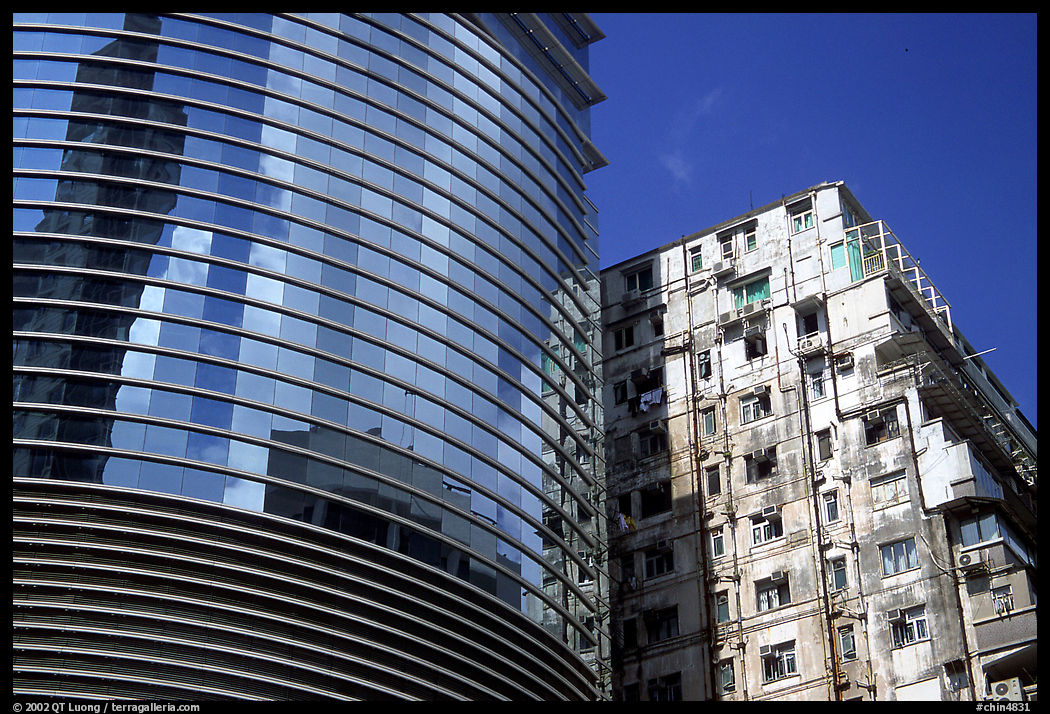 Glass building aside an old building, Kowloon. Hong-Kong, China