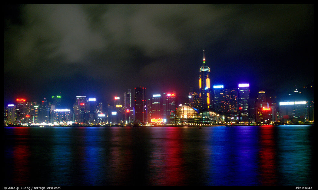 Colorful reflexions of Hong-Kong Island lights across the harbor by night. Hong-Kong, China