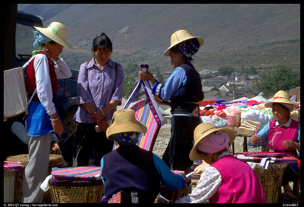 Bai women wearing tribespeople dress at the Monday market. Shaping, Yunnan, China