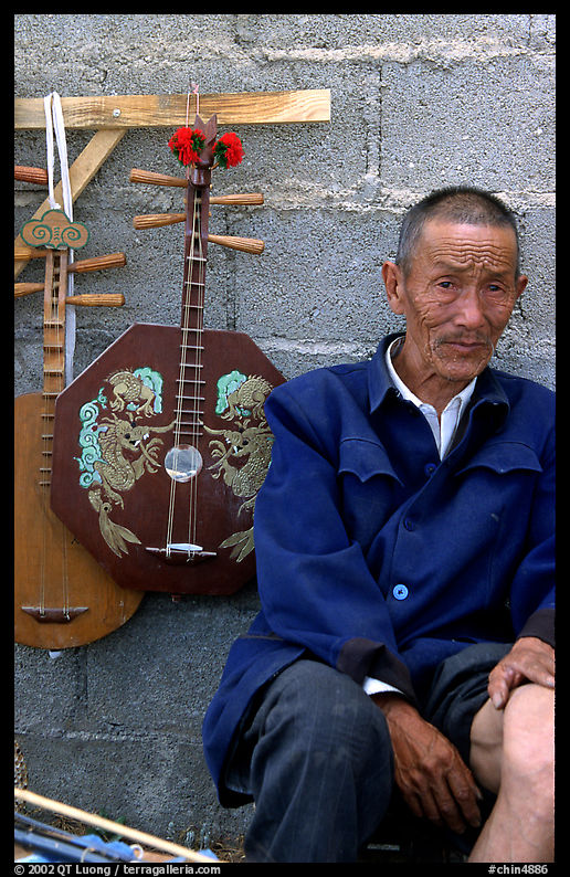 Man selling musical instruments. Shaping, Yunnan, China
