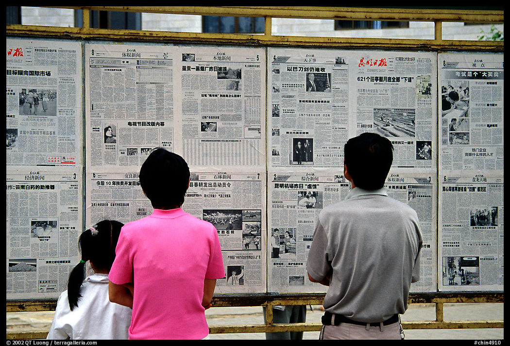 Reading dazibao (public newspapers). Kunming, Yunnan, China