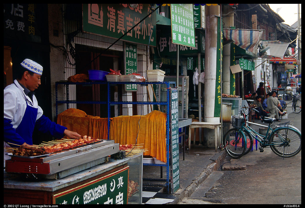 Muslim cook at restaurant storefront. Kunming, Yunnan, China