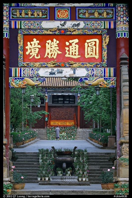 Monk on entrance alley of Yantong Si. Kunming, Yunnan, China