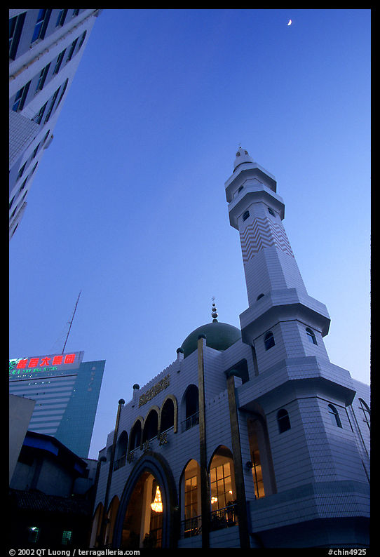 Nancheng Mosque built recently, a hybrid of white-tiled high rise with a mosque's green onion domes. Kunming, Yunnan, China