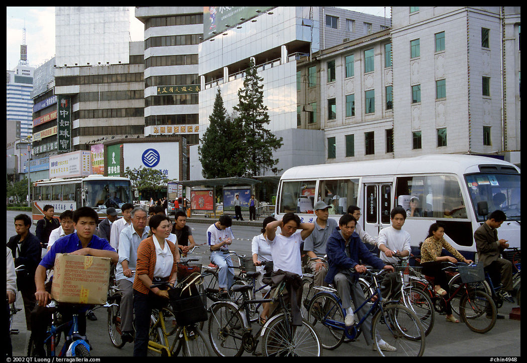 Bicyclists waiting for traffic light. Kunming, Yunnan, China