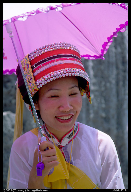 Woman from the Sani branch of the Yi tribespeople with a sun unbrella. Shilin, Yunnan, China