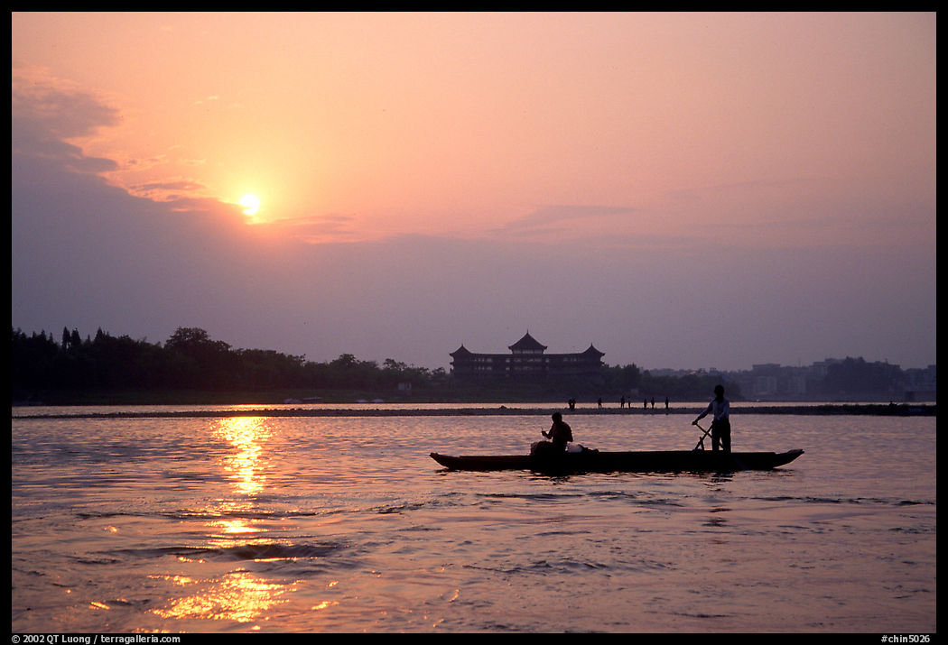 Fishermen at the confluence of the Dadu He and Min He rivers at sunset. Leshan, Sichuan, China