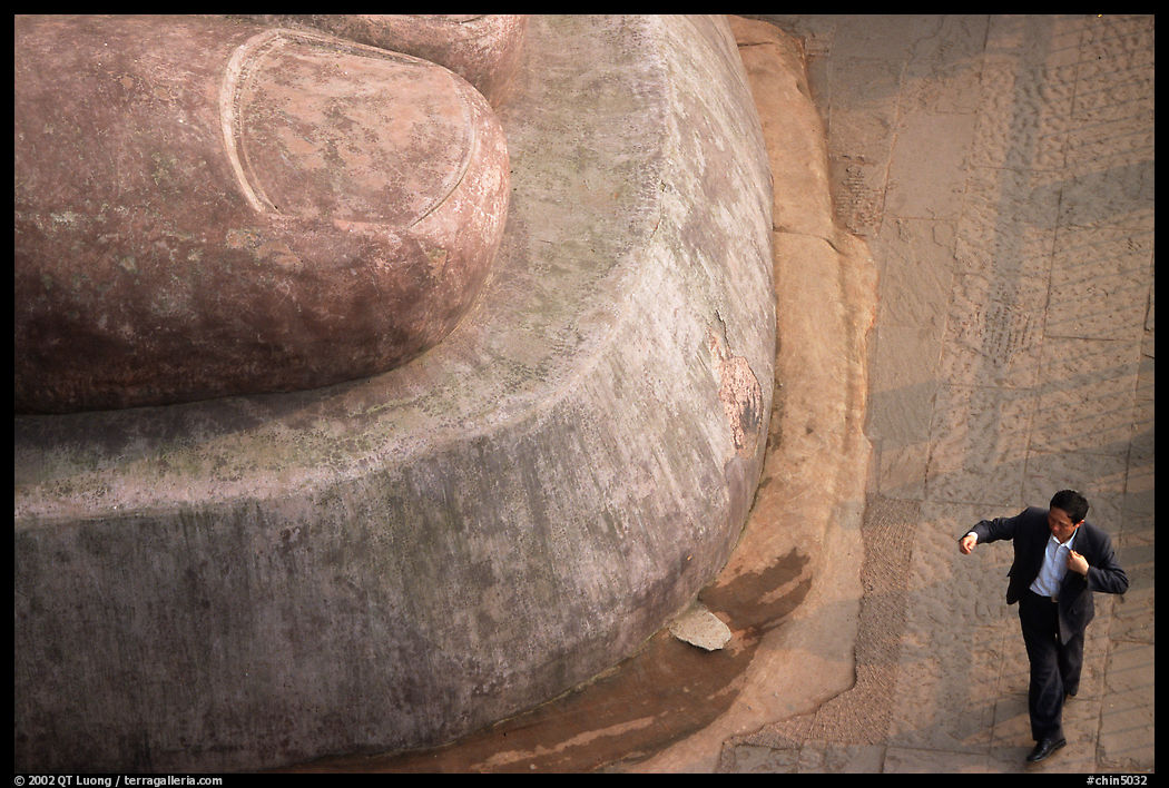 Man standing next to the toe of the Grand Buddha. Leshan, Sichuan, China