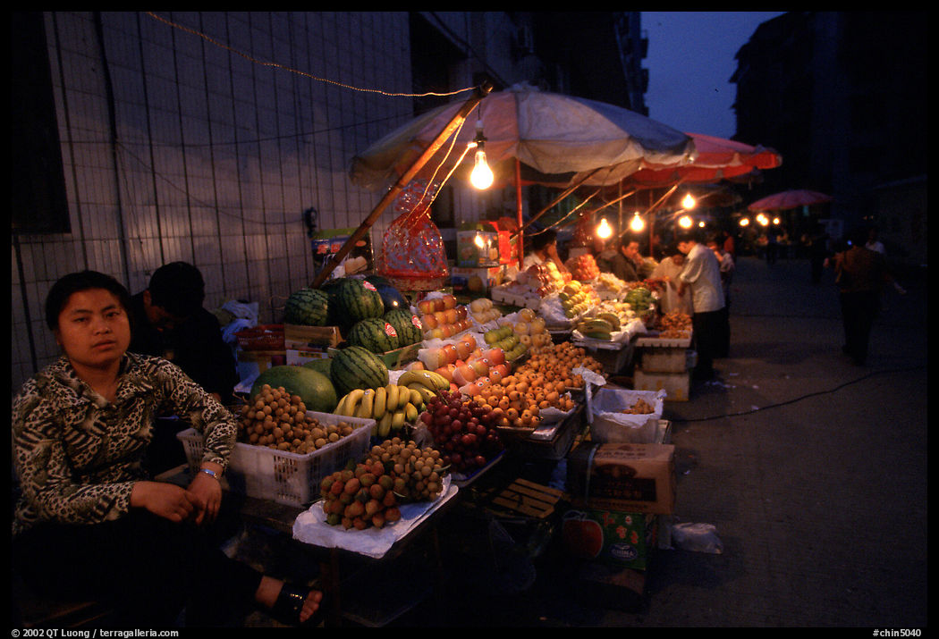 Fruit vendor, night market. Leshan, Sichuan, China