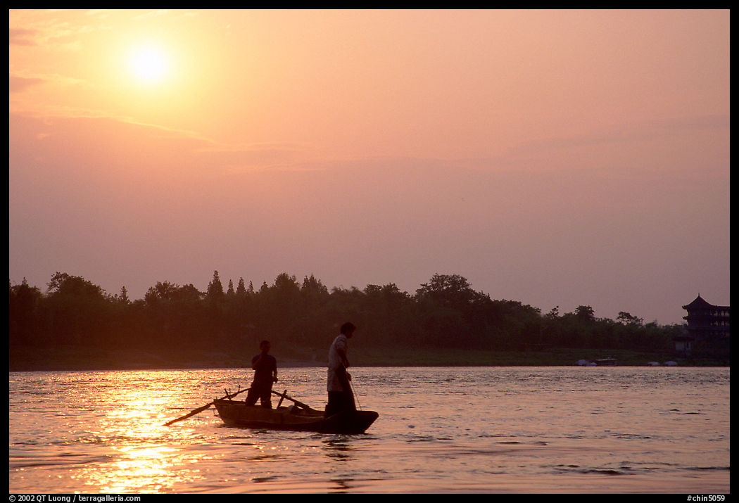 Fishermen at the confluence of the Dadu He and Min He rivers at sunset. Leshan, Sichuan, China