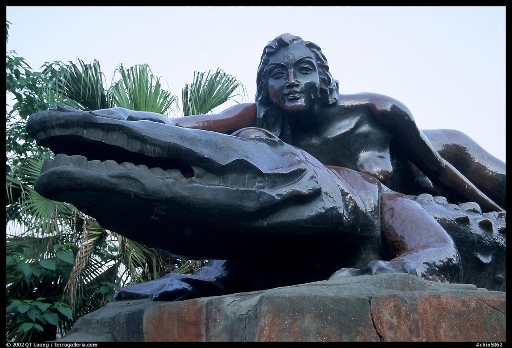 Odd sculpure of a naked woman with a crocodile. Leshan, Sichuan, China