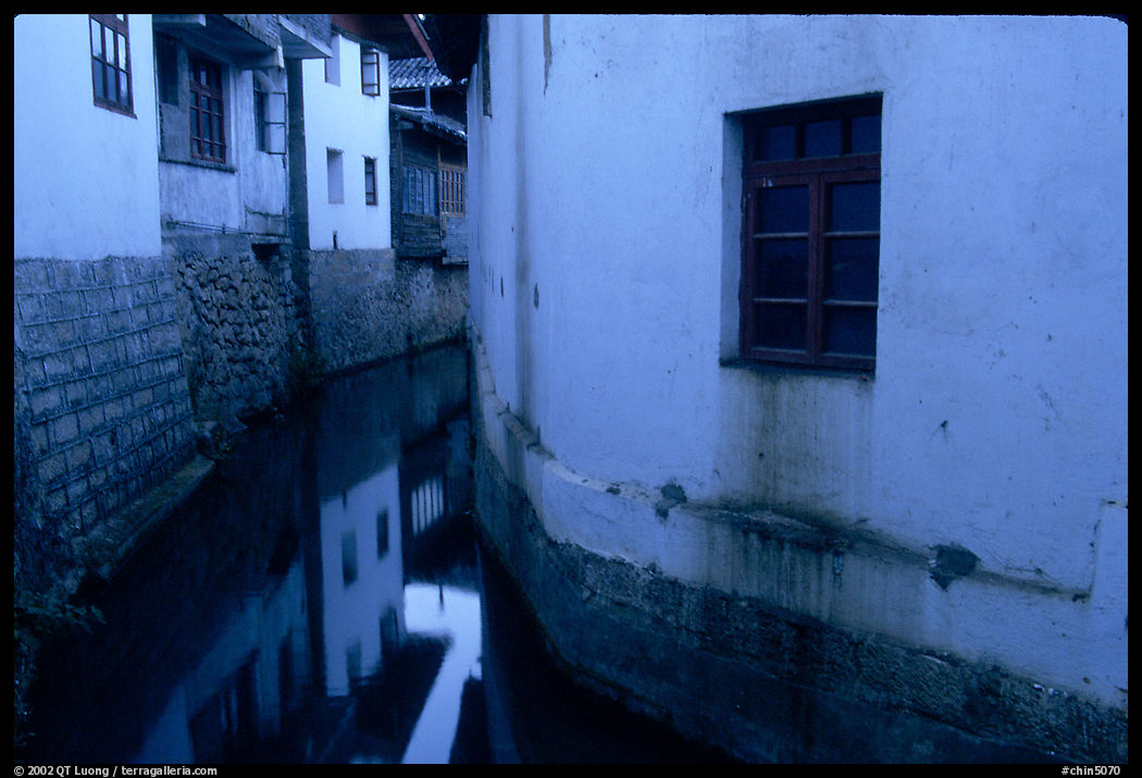 White walled houses surrounding a canal. Lijiang, Yunnan, China