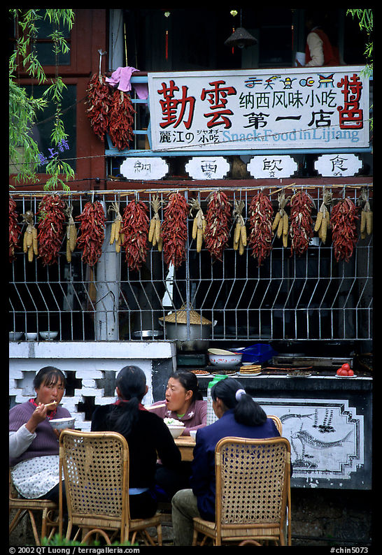 Women eat outside the Snack Food in Lijiang restaurant. Lijiang, Yunnan, China