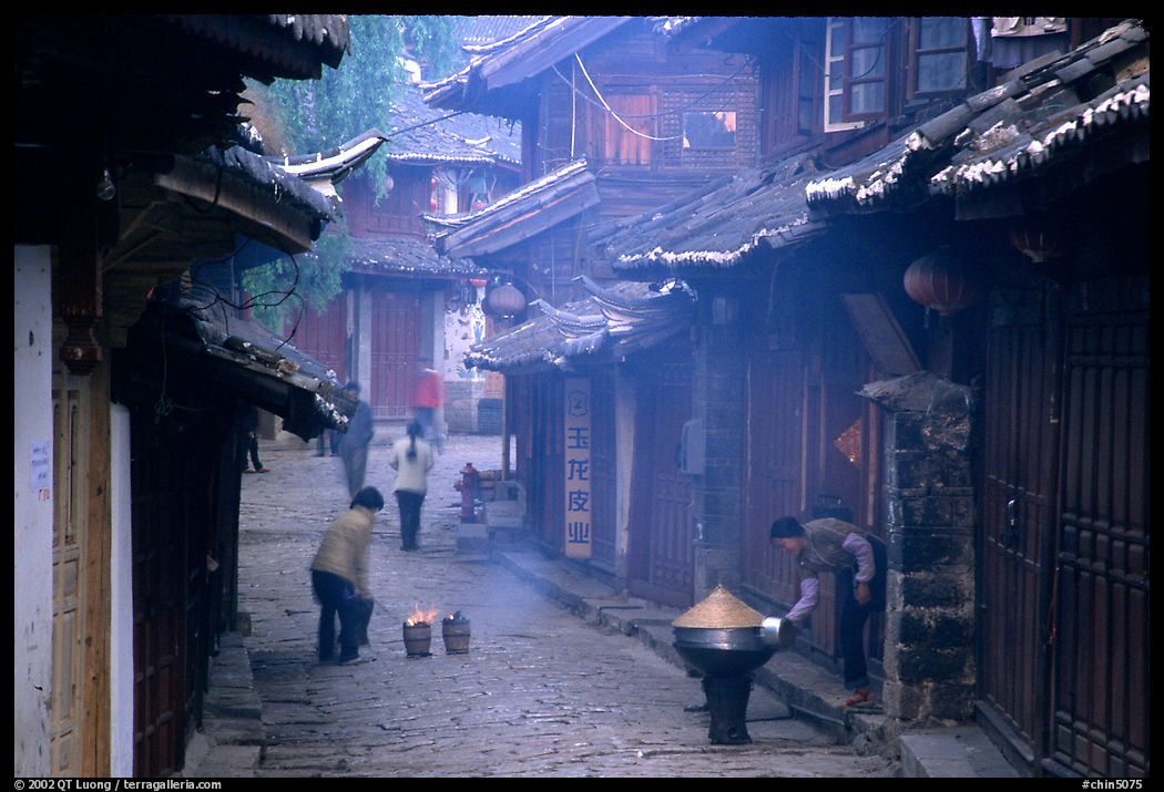 Street in the morning with dumplings being cooked. Lijiang, Yunnan, China