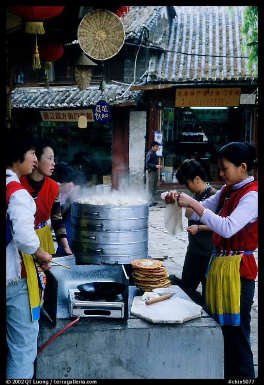 Naxi women selling dumplings and Naxi baba flatbread. Lijiang, Yunnan, China