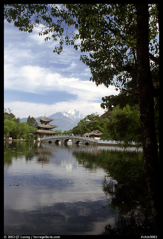 Pavillon reflected in the Black Dragon Pool, with Jade Dragon Snow Mountains in the background. Lijiang, Yunnan, China