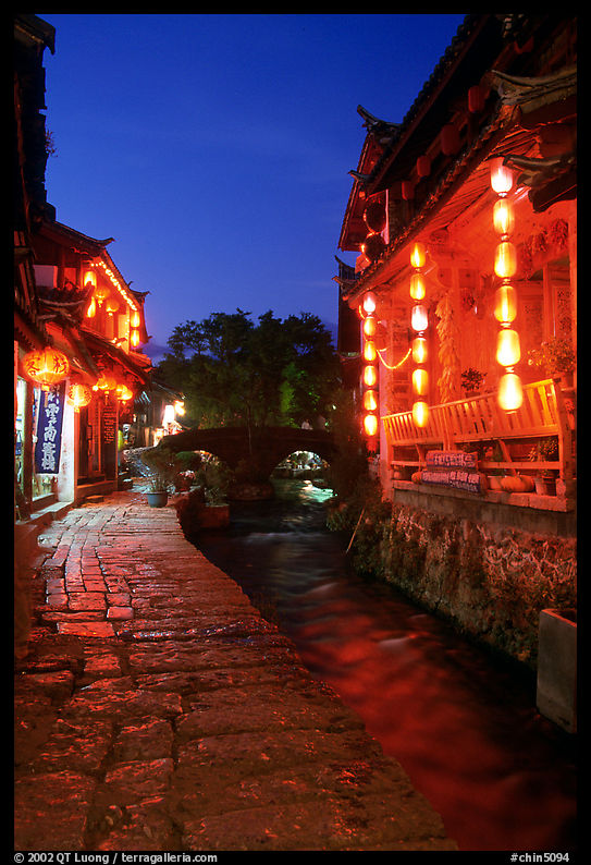 Cobblestone street and canal at night. Lijiang, Yunnan, China