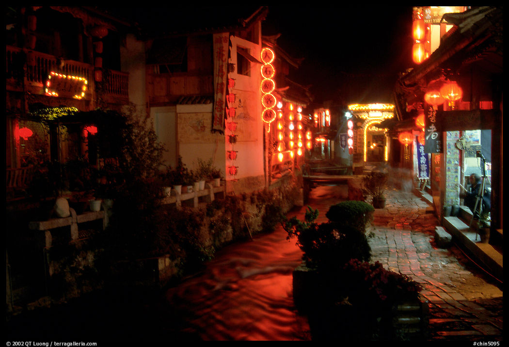 Red lanterns reflected in a canal at night. Lijiang, Yunnan, China