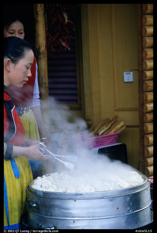 Naxi Women baking dumplings. Lijiang, Yunnan, China