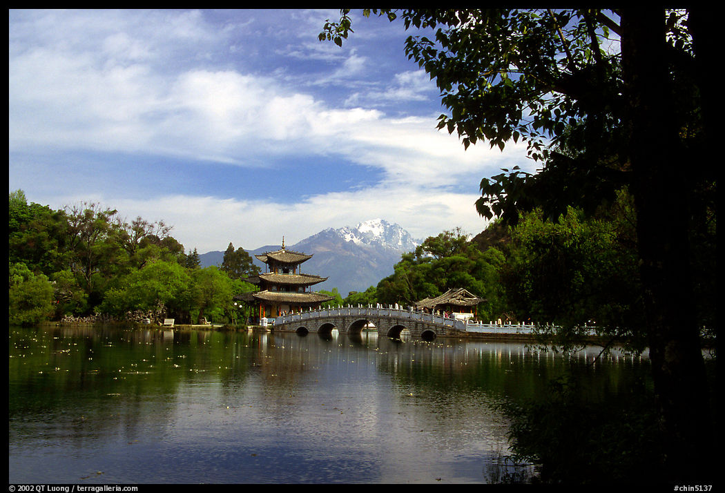 Pavillon reflected in the Black Dragon Pool, with Jade Dragon Snow Mountains in the background. Lijiang, Yunnan, China