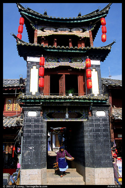 Woman under the Kegong tower archway. Lijiang, Yunnan, China