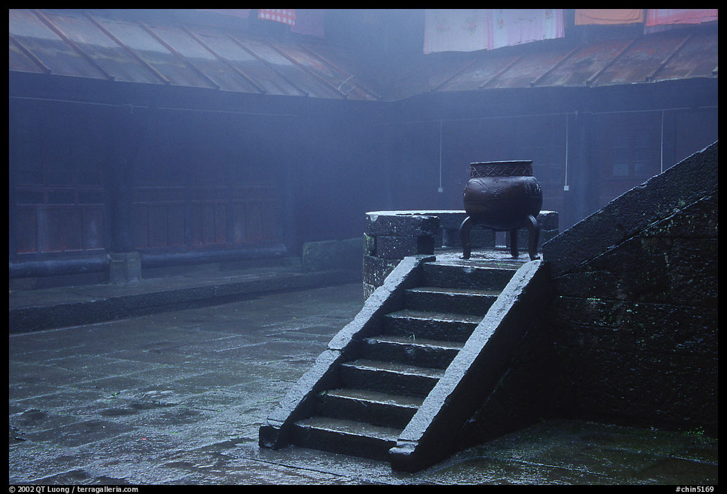 Urn and stairs in courtyard of Xiangfeng temple in fog. Emei Shan, Sichuan, China